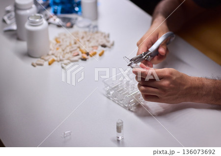 Cleaning and mixing medicines with precision craftsmanship, Detailed scene of meticulous drug processing involving tablet grinding and precise pharmaceutical handling Cleaning and mixing medicines with precision craftsmanship, Detailed scene of meticulous drug processing involving tablet grinding and precise pharmaceutical handling 136073692