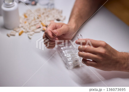 Cleaning and mixing medicines with precision craftsmanship, Detailed scene of meticulous drug processing involving tablet grinding and precise pharmaceutical handling 136073695