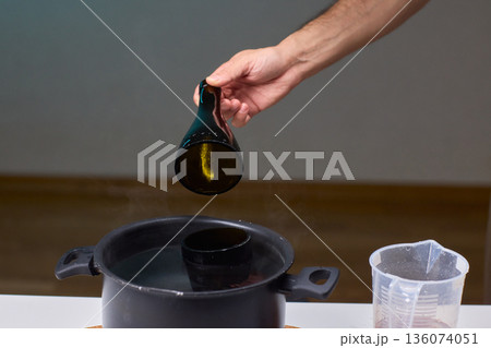 Precise technique for transforming bottles into functional decor pieces, Detailed method of utilizing heat and protective gear to repurpose glass containers into decorative items 136074051