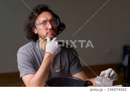 Precise technique for transforming bottles into functional decor pieces, Detailed method of utilizing heat and protective gear to repurpose glass containers into decorative items 136074082