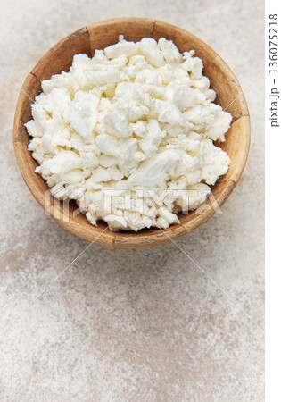 Cottage cheese in wooden bowl on rustic background 136075218