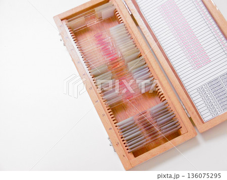 Wooden Slide Box Filled With Stacked Slides, Colorful Labels And Glass Specimens Visible Under Soft Light, 136075295