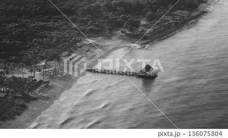 Aerial view of a small hut on a wooden pier on Bayahibe beach and caribbean sea 136075804