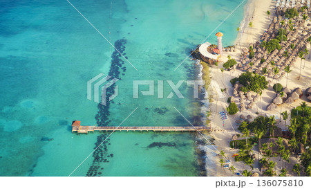 Top view of a lighthouse and wooden pier on Bayahibe beach with turquoise sea Top view of a lighthouse and wooden pier on Bayahibe beach with turquoise sea 136075810