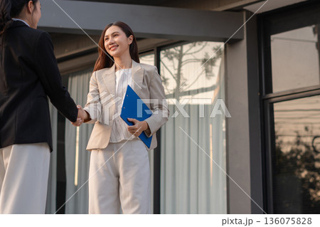 Business women shake hands after agreeing to start a new project successfully. Business women shake hands after agreeing to start a new project successfully. 136075828