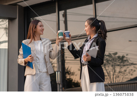 Happy business team collaborates and enjoys coffee while sharing creative ideas in a modern office. teamwork success. Happy business team collaborates and enjoys coffee while sharing creative ideas in a modern office. teamwork success. 136075838
