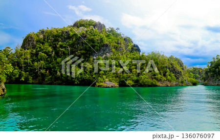 beautiful view of island and sea with clear sky background, West Papua, Indonesia beautiful view of island and sea with clear sky background, West Papua, Indonesia 136076097