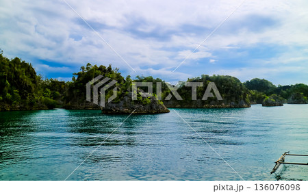 beautiful view of island and sea with clear sky background, West Papua, Indonesia beautiful view of island and sea with clear sky background, West Papua, Indonesia 136076098