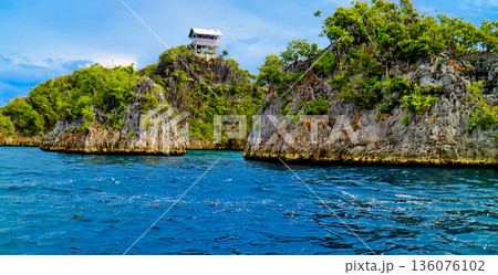 beautiful view of island and sea with clear sky background, West Papua, Indonesia beautiful view of island and sea with clear sky background, West Papua, Indonesia 136076102