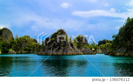 beautiful view of island and sea with clear sky background, West Papua, Indonesia 136076112