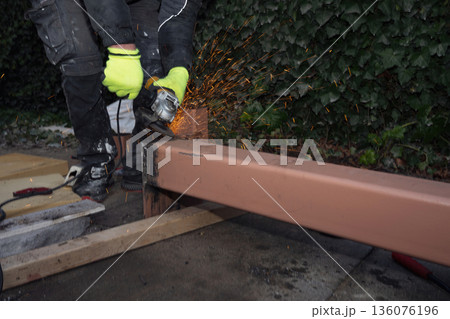 Angle Grinder Cutting Steel Beam with Flying Sparks 136076196