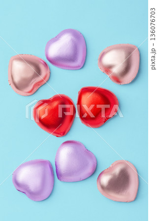 Heart chocolate with colorful foil wrapped on blue background 136076703