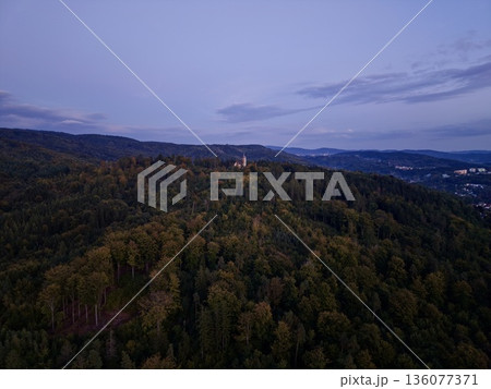 Forest Encircled Tower Under Evening Sky, Peaceful Hilltop Tower Standing Amidst Trees As Sunset Fades 136077371