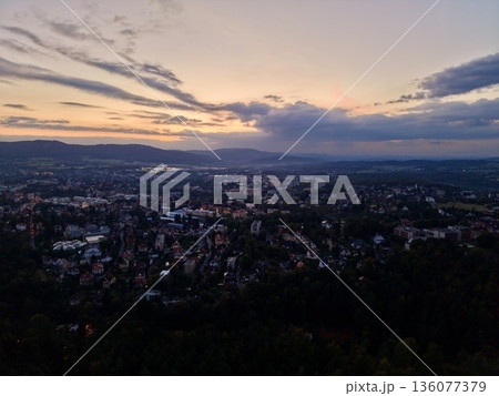 Vibrant Sunset Panorama, Colorful Sunset Over Cityscape, Dramatic Evening Sky Highlights City Silhouette 136077379