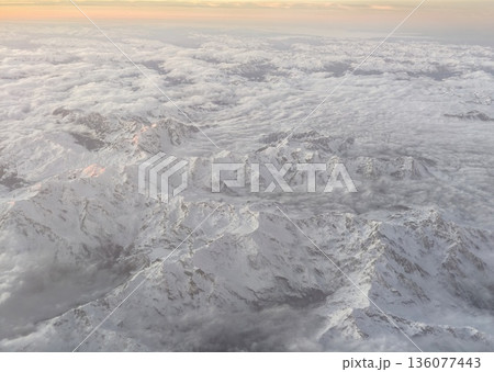Remote icy mountain range with clear cold atmosphere emphasizing untouched natural wilderness 136077443