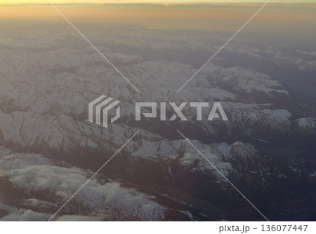 Snowy summits bathed in twilight, Serene mountain landscape illuminated by gentle golden evening light Snowy summits bathed in twilight, Serene mountain landscape illuminated by gentle golden evening light 136077447