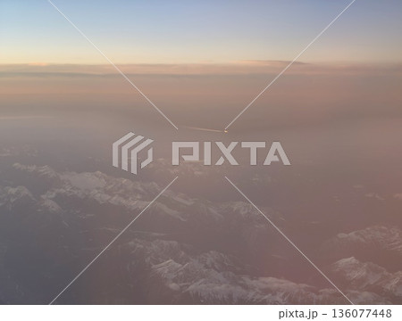 Calm pastel sky over snowcapped summits, Gentle horizon with muted colors and icy mountain ridges Calm pastel sky over snowcapped summits, Gentle horizon with muted colors and icy mountain ridges 136077448