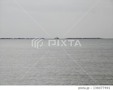 Serene landscape of distant maritime refuge, Sparse horizon view suggesting navigation and longing mood 136077491