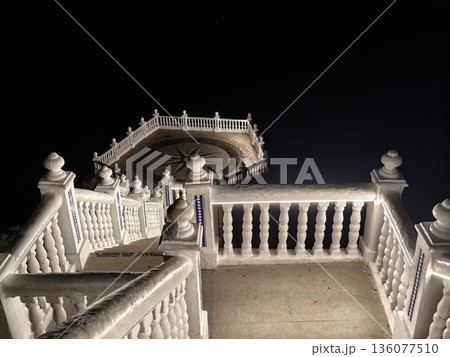Silent terrace with dark illuminated balustrade, Nighttime scene featuring aged steps and shadowed balustrade 136077510