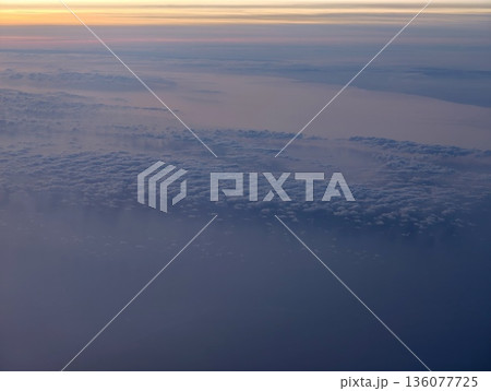 Solitary pilot experiences peaceful twilight hours soaring over distant cloud formations and pale horizon Solitary pilot experiences peaceful twilight hours soaring over distant cloud formations and pale horizon 136077725