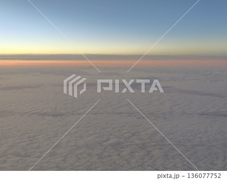 Early morning aerial view showcasing gentle glow and expansive cloud cover in tranquil setting Early morning aerial view showcasing gentle glow and expansive cloud cover in tranquil setting 136077752