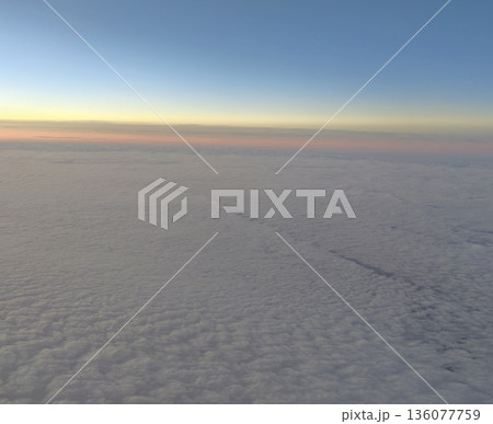 Expansive early morning cloud formation blending gentle pastel colors with calming horizon glow for relaxation Expansive early morning cloud formation blending gentle pastel colors with calming horizon glow for relaxation 136077759