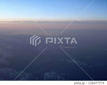 Peaceful view over lake at sunset, Tranquil horizon blending sky and water during evening hours 136077774