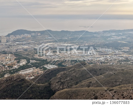 Relaxed viewpoint displaying broad seaside improvements with surrounding hills and buildings 136077883