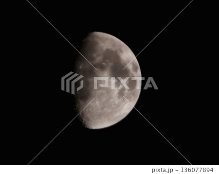 Minimalist depiction of halflit moon against deep night sky with shadows and sharp terminator Minimalist depiction of halflit moon against deep night sky with shadows and sharp terminator 136077894