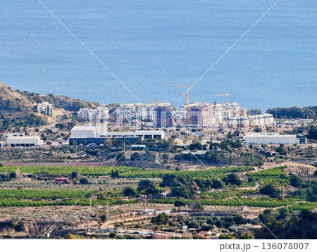 Coastal landscape with hills and sea, Tranquil coastline featuring rolling hills and reflective waters 136078007