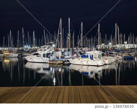 Elegant vessels resting at calm marina, Refined yachts moored on serene waterfront at sunset 136078010