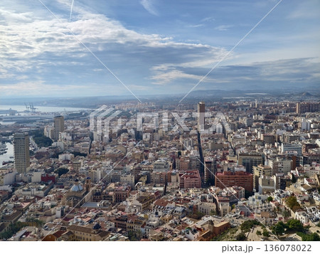 Skyline with harbor, City view with water and mountains, Urban scene featuring rooftops and distant hills 136078022