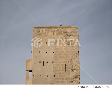 Ancient sandstone structure with solitude, Eroded structure featuring vertical lines and peaceful ambiance Ancient sandstone structure with solitude, Eroded structure featuring vertical lines and peaceful ambiance 136078029