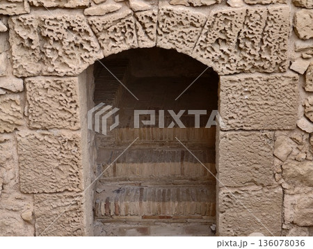 Ancient stone archway leading inward, Old stone staircase hidden within narrow historic building opening Ancient stone archway leading inward, Old stone staircase hidden within narrow historic building opening 136078036