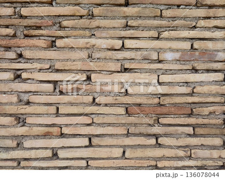 Brick wall aesthetics, Closeup of aged brick wall showing layered terracotta and fine mortar lines Brick wall aesthetics, Closeup of aged brick wall showing layered terracotta and fine mortar lines 136078044