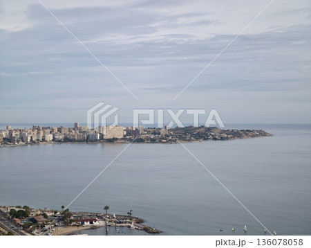 Serene waterfront city view at dawn, Quiet bay with urban buildings and boats reflecting morning light Serene waterfront city view at dawn, Quiet bay with urban buildings and boats reflecting morning light 136078058