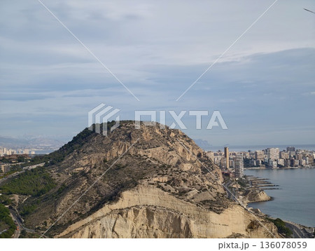 Rugged mountain rise presenting sweeping vistas of shoreline and metropolitan skyline below Rugged mountain rise presenting sweeping vistas of shoreline and metropolitan skyline below 136078059