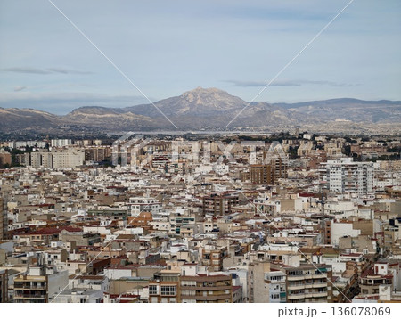 Serene hillside with urban structures, Peaceful mountain view overlooking cityscape and residences Serene hillside with urban structures, Peaceful mountain view overlooking cityscape and residences 136078069