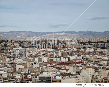 Urban area with varied rooftops, Dense city neighborhood featuring muted tones and distant hills Urban area with varied rooftops, Dense city neighborhood featuring muted tones and distant hills 136078070