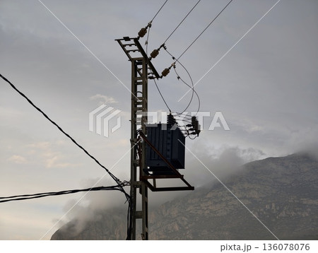 Rusty pole with transformer weathered, Aging electrical infrastructure servicing isolated mountain cabin 136078076