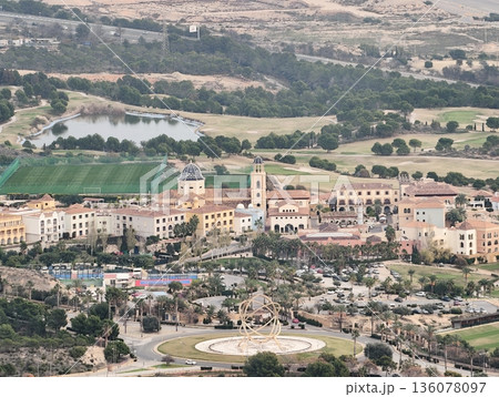 Serene Mediterranean town surrounded by hills, Picturesque village with charming streets and lush greenery Serene Mediterranean town surrounded by hills, Picturesque village with charming streets and lush greenery 136078097