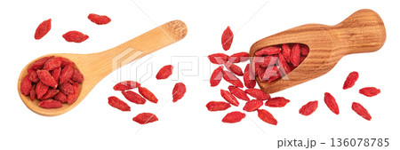 Dried goji berries in wooden spoon and scoop isolated on white background. Top view. Flat lay. Dried goji berries in wooden spoon and scoop isolated on white background. Top view. Flat lay. 136078785