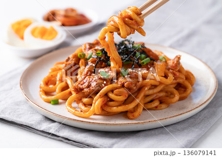 Stir fried Udon noodle with kimchi cabbage, pork, spring onion, sesame seed and seaweed on top Stir fried Udon noodle with kimchi cabbage, pork, spring onion, sesame seed and seaweed on top 136079141