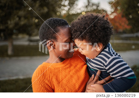 Mother and son bonding with affection outdoors Mother and son bonding with affection outdoors 136080219