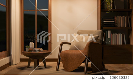 Wooden chair with pillow and blanket with table aside window and bookshelf in living room or library Wooden chair with pillow and blanket with table aside window and bookshelf in living room or library 136080325