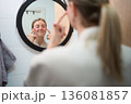 A Gentle Pause While Applying Eye Patches 136081857