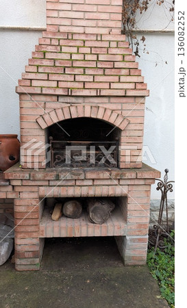 Close view of traditional fire pit with embers and logs 136082252