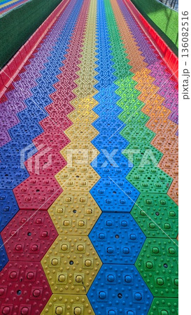 Rainbow Slide With Vibrant Surroundings, Fast And Thrilling Ride Through Vivid Rainbow Themed Scenery 136082516