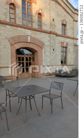 A Charming Outdoor Patio Featuring Stylish and Modern Furniture Along with Warm, Inviting Lighting A Charming Outdoor Patio Featuring Stylish and Modern Furniture Along with Warm, Inviting Lighting 136082712