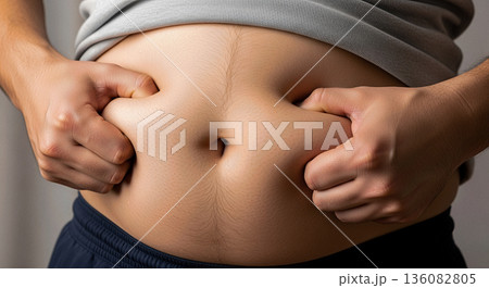 Overweight man pinching belly fat with both hands close up obesity weight loss concept diet health care problem body shape Overweight man pinching belly fat with both hands close up obesity weight loss concept diet health care problem body shape 136082805